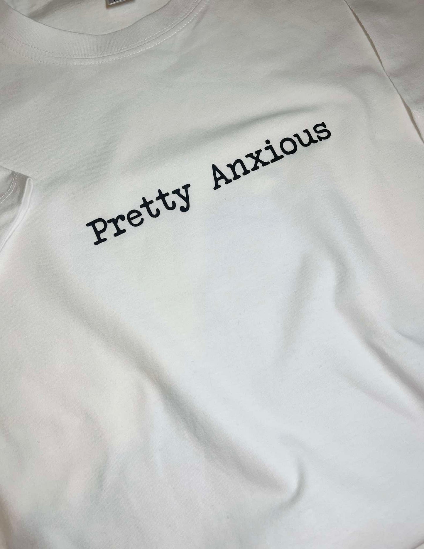 White round neck t-shirt with the text 'Pretty Anxious' printed on the front.