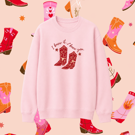 Pink sweatshirt with cowboy boot design and text on a patterned background