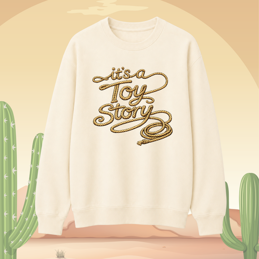 Vanilla sweatshirt with 'it's a Toy Story' text on a beige background with cacti.