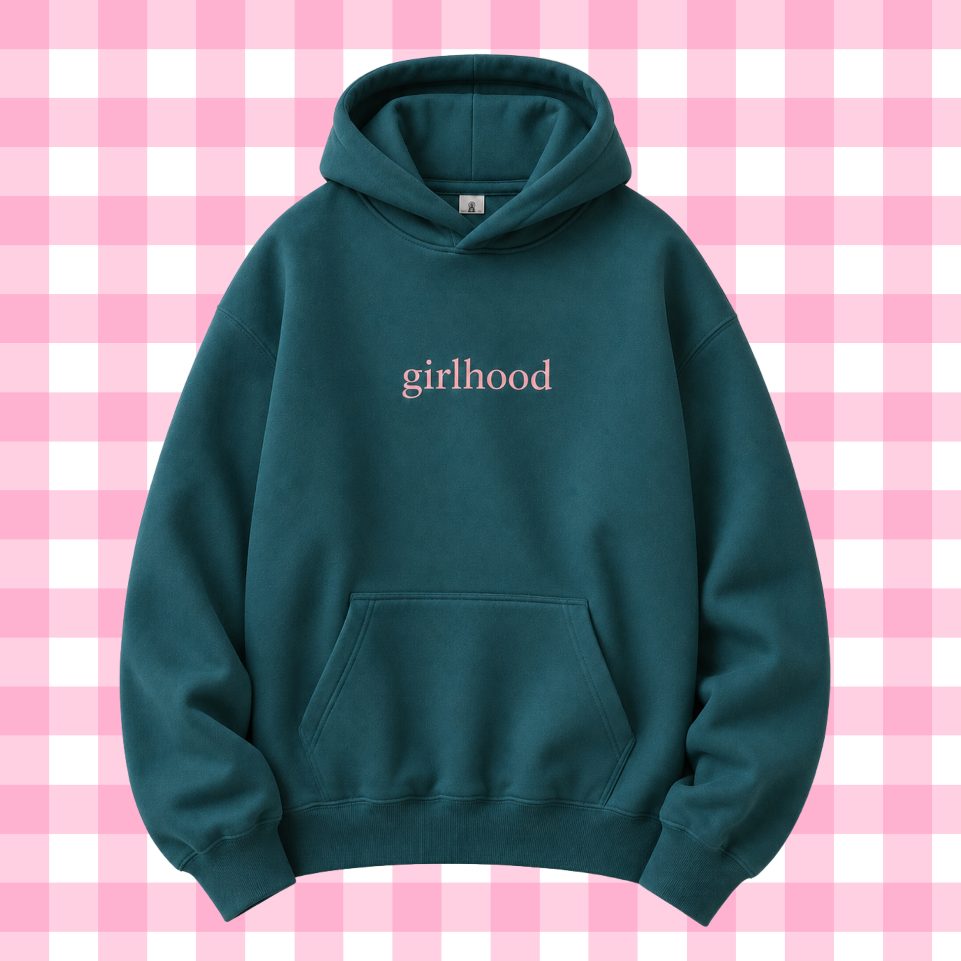 A dark teal-green pullover hoodie with the word 'girlhood' printed in a light pink serif font on the chest, displayed against a pink and white checkered background.