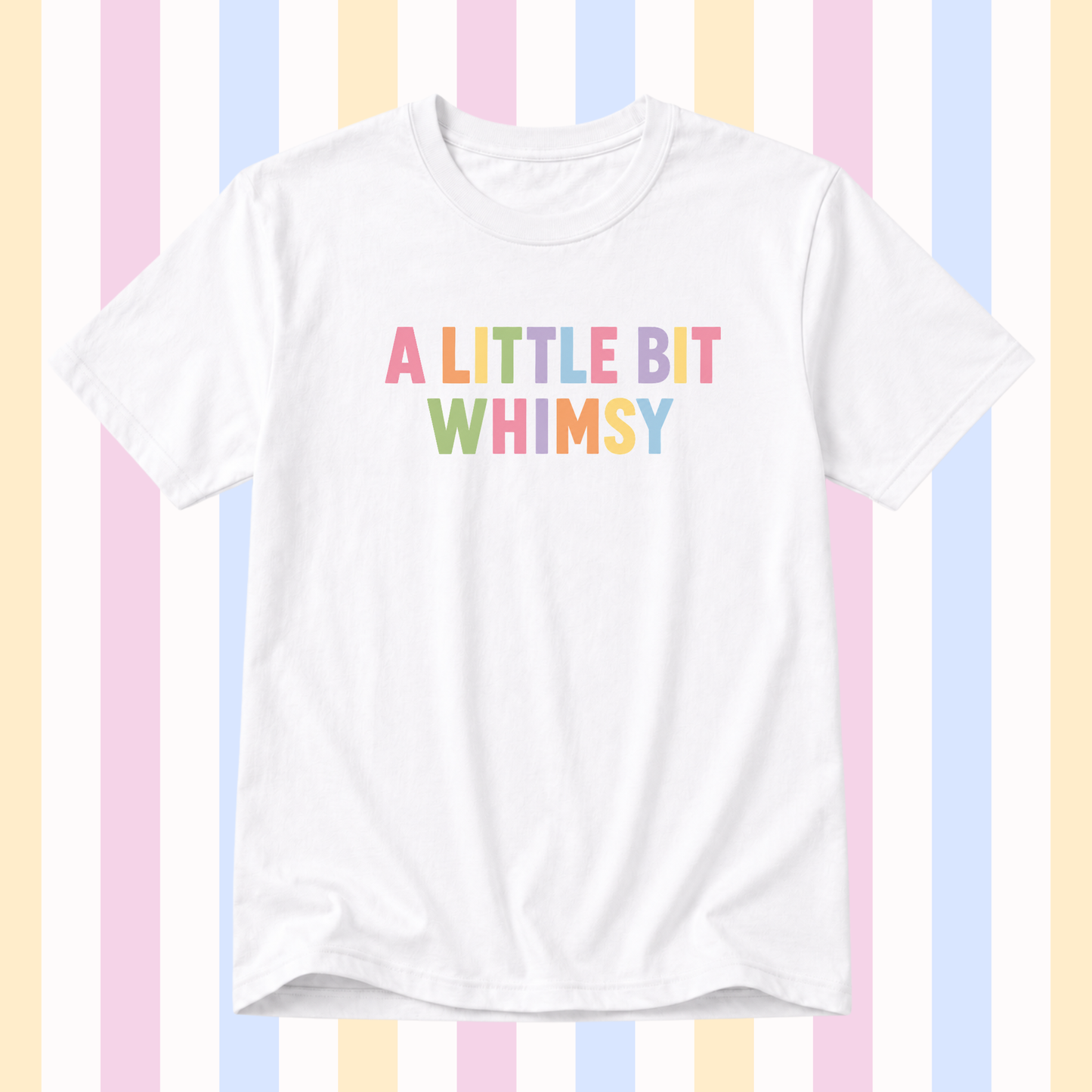 A white short-sleeve crewneck t-shirt featuring the text 'A LITTLE BIT WHIMSY' printed on the chest in a pastel rainbow font, set against a background of vertical pastel stripes.