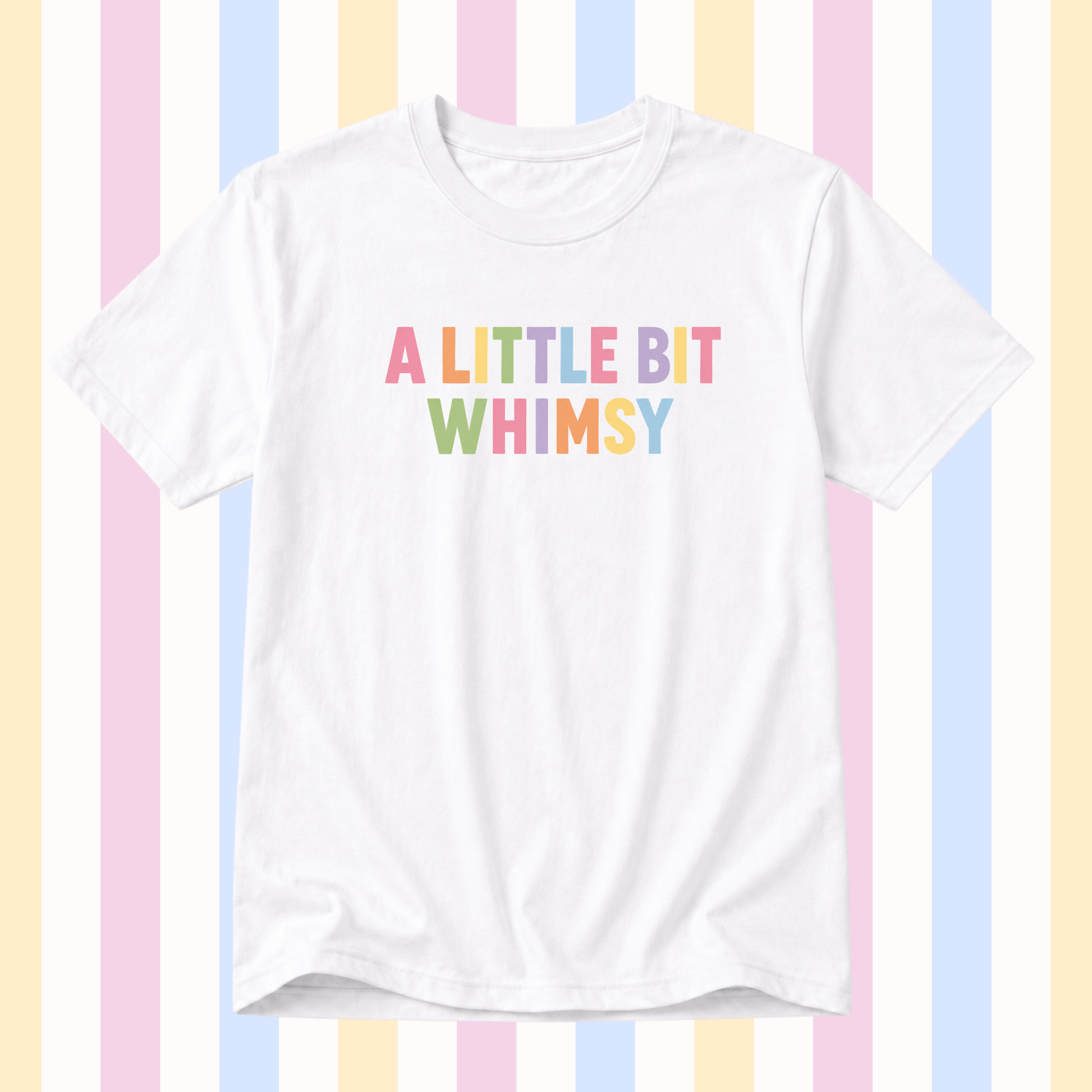 A white short-sleeve crewneck t-shirt featuring the text 'A LITTLE BIT WHIMSY' printed on the chest in a pastel rainbow font, set against a background of vertical pastel stripes.