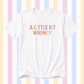 A white short-sleeve crewneck t-shirt featuring the text 'A LITTLE BIT WHIMSY' printed on the chest in a pastel rainbow font, set against a background of vertical pastel stripes.