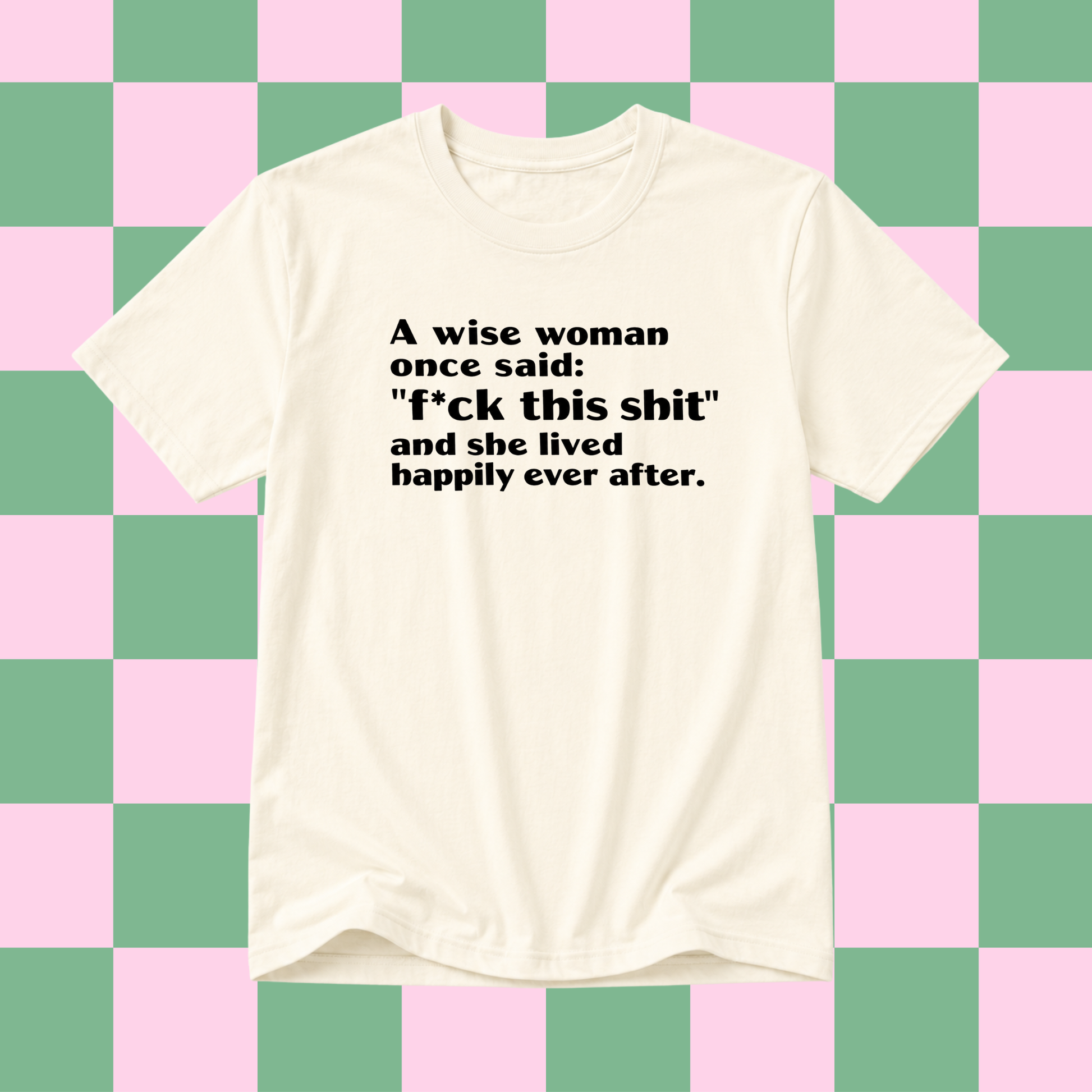 An off-white short-sleeve t-shirt with black printed text on the chest, displayed against a pink and green checkered background.