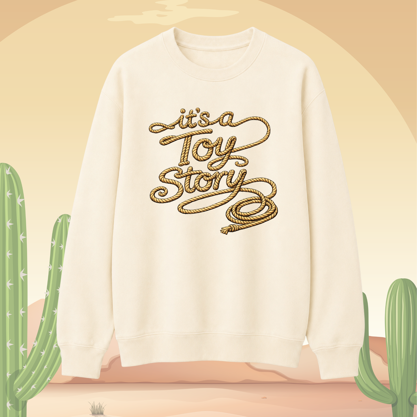 Vanilla sweatshirt with 'it's a Toy Story' text on a beige background with cacti.