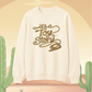 Vanilla sweatshirt with 'it's a Toy Story' text on a beige background with cacti.