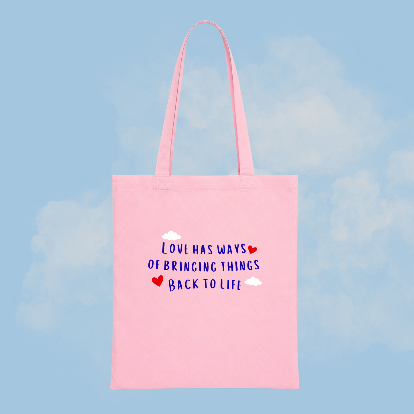 Pink tote bag with motivational quote on a blue background