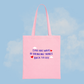 Pink tote bag with motivational quote on a blue background