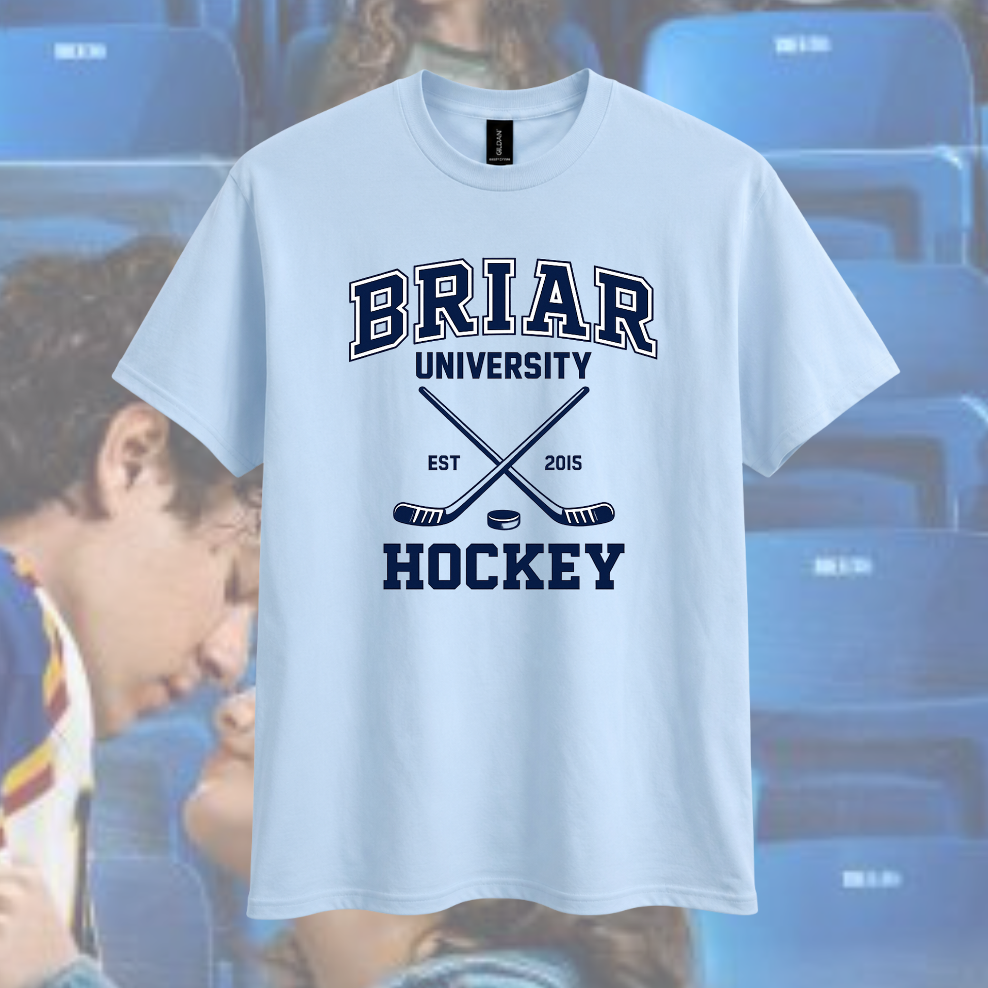 White t-shirt with 'BRIAR UNIVERSITY HOCKEY' text and graphics on a blurred background