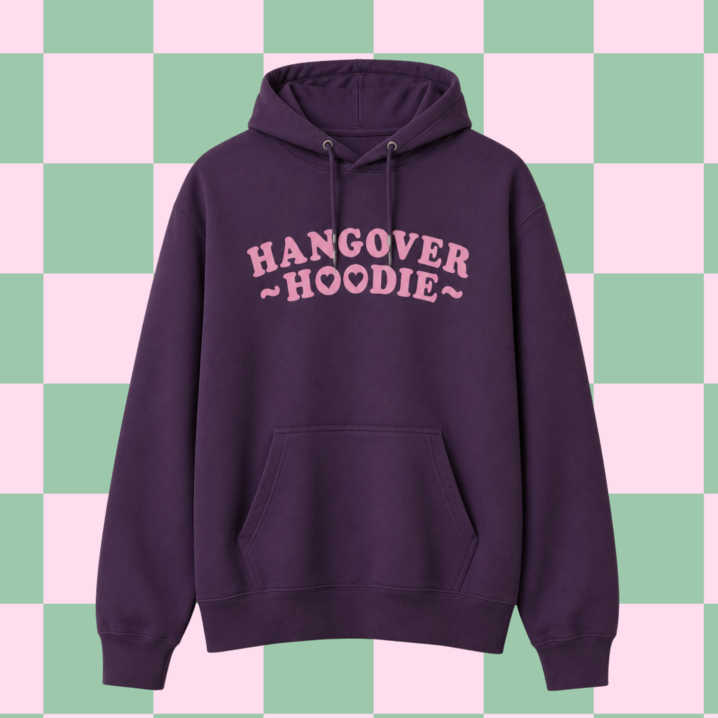 A dark purple pullover hoodie with 'HANGOVER HOODIE' printed in pink across the chest, displayed against a pastel pink and green checkered background.