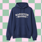 A navy blue pullover hoodie with 'HANGOVER HOODIE' printed in white across the chest, shown against a pink and green checkered background.