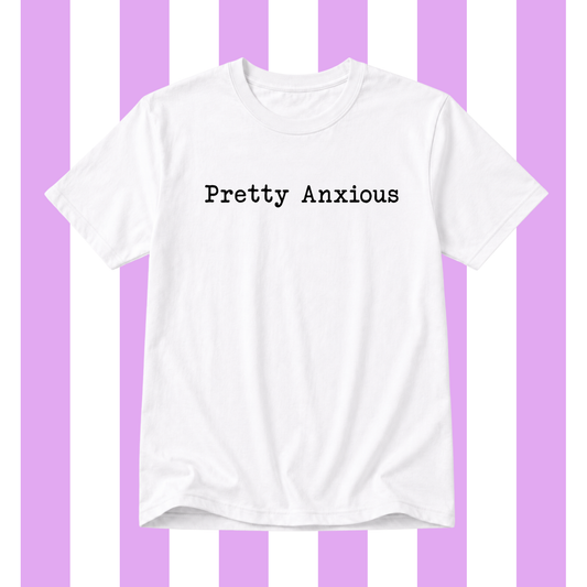 A white short-sleeve crewneck t-shirt with the text 'Pretty Anxious' printed in black typewriter font across the chest, displayed against a background of vertical lavender and white stripes.