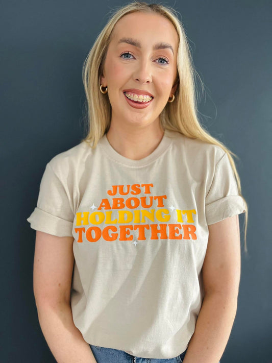 JUST ABOUT HOLDING IT TOGETHER TEE